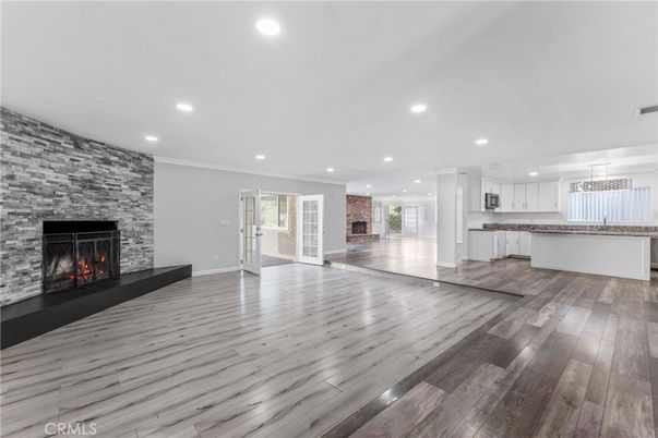 Empty room, Fireplace, Interior, Kitchen, Pendant Lights, Recessed Lighting, Stone Walls, Wood Texture Flooring
