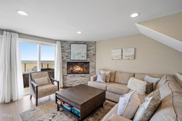 Fireplace, Interior, Living room, Recessed Lighting, Stone Walls, Water, Wood Texture Flooring