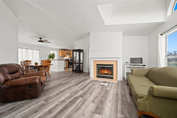 Dining room, Fireplace, Interior, Kitchen, Living room, Recessed Lighting, Stainless Steel Appliances, Wood Texture Flooring