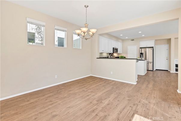 Chandelier, Empty room, Interior, Kitchen, Recessed Lighting, Stainless Steel Appliances, Wood Texture Flooring