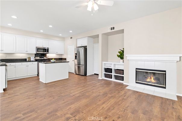Fireplace, Interior, Kitchen, Recessed Lighting, Stainless Steel Appliances, Wood Texture Flooring