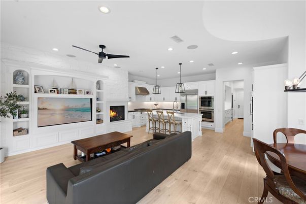 Fireplace, Interior, Kitchen, Living room, Pendant Lights, Recessed Lighting, Stainless Steel Appliances, Wood Texture Flooring