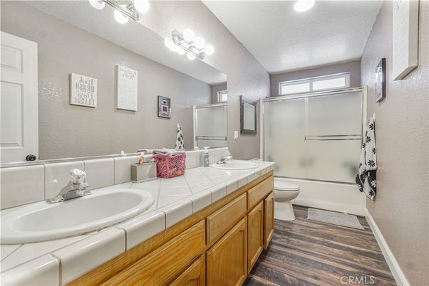 Bathroom, Dual Sink Vanities, Glass Shower, Interior, Recessed Lighting, Tile Countertops, Wood Texture Flooring