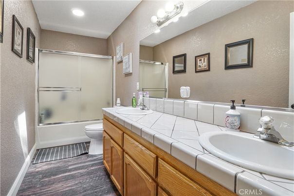 Bathroom, Dual Sink Vanities, Glass Shower, Interior, Recessed Lighting, Tile Countertops, Wood Texture Flooring