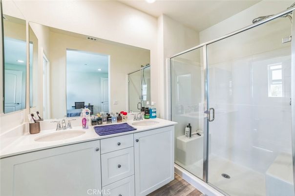 Bathroom, Dual Sink Vanities, Glass Shower, Interior, Recessed Lighting, Wood Texture Flooring