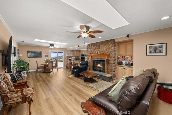 Dining room, Fireplace, Interior, Living room, Recessed Lighting, Stone Walls, Wood Texture Flooring