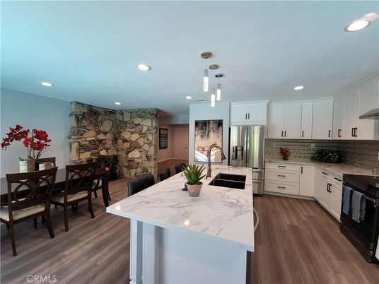 Dining room, Interior, Kitchen, Pendant Lights, Recessed Lighting, Stainless Steel Appliances, Stone Walls, Wood Texture Flooring