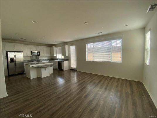 Empty room, Interior, Kitchen, Recessed Lighting, Stainless Steel Appliances, Wood Texture Flooring