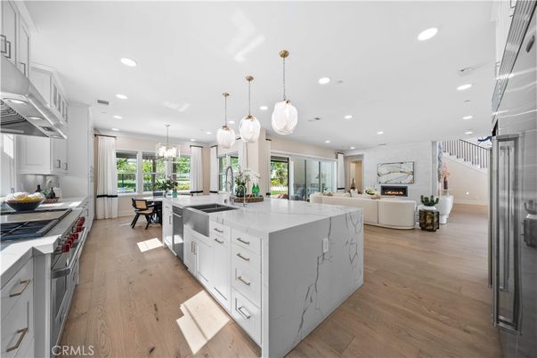 Dining room, Fireplace, Interior, Kitchen, Living room, Pendant Lights, Recessed Lighting, Stainless Steel Appliances, Wood Texture Flooring