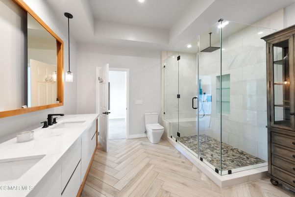Bathroom, Dual Sink Vanities, Glass Shower, Interior, Marble Walls, Pendant Lights, Recessed Lighting, Wood Texture Flooring