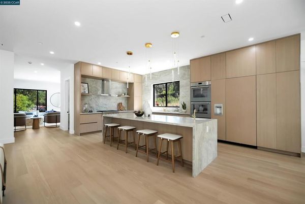 Interior, Kitchen, Marble Walls, Pendant Lights, Recessed Lighting, Stainless Steel Appliances, Wood Texture Flooring