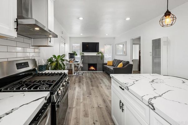 Fireplace, Interior, Kitchen, Living room, Pendant Lights, Recessed Lighting, Stainless Steel Appliances, Wood Texture Flooring
