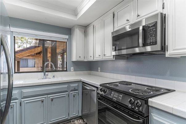 Interior, Kitchen, Stainless Steel Appliances, Tile Countertops, Wood Texture Flooring