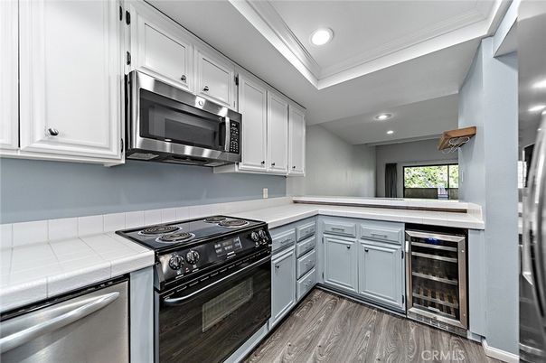 Interior, Kitchen, Recessed Lighting, Stainless Steel Appliances, Tile Countertops, Wood Texture Flooring