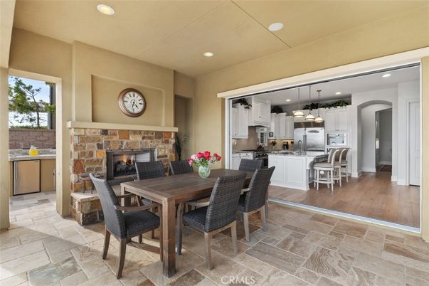 Dining room, Fireplace, Interior, Kitchen, Pendant Lights, Recessed Lighting, Stainless Steel Appliances, Wood Texture Flooring