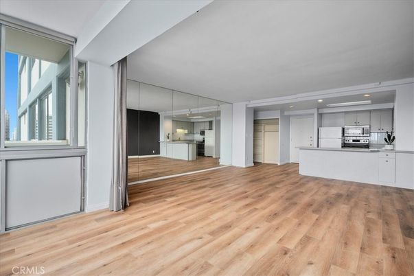 Empty room, Interior, Kitchen, Recessed Lighting, Stainless Steel Appliances, Wood Texture Flooring
