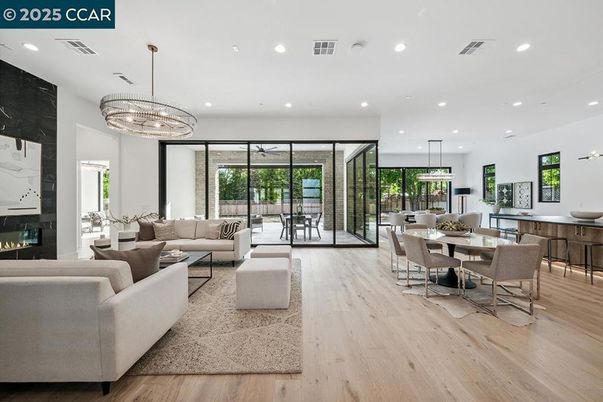Chandelier, Dining room, Fireplace, Interior, Living room, Pendant Lights, Recessed Lighting, Wood Texture Flooring