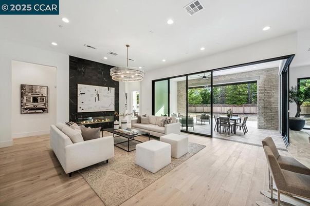 Chandelier, Dining room, Fireplace, Interior, Living room, Pendant Lights, Recessed Lighting, Wood Texture Flooring