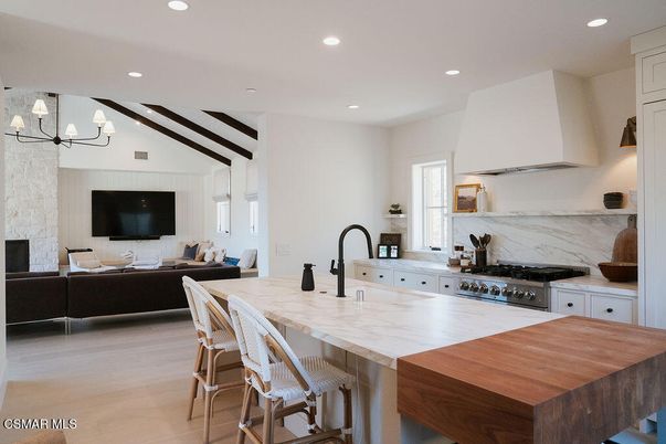 Chandelier, Fireplace, Interior, Kitchen, Living room, Marble Walls, Recessed Lighting, Stainless Steel Appliances, Wooden Beams, Wood Texture Flooring