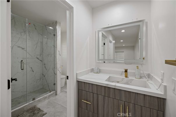 Bathroom, Dual Sink Vanities, Glass Shower, Interior, Marble, Marble Walls, Recessed Lighting