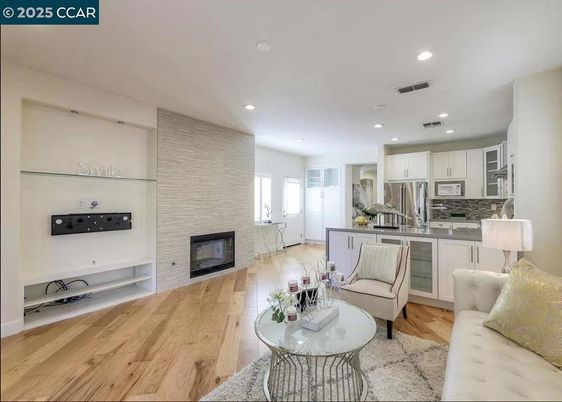 Fireplace, Interior, Kitchen, Living room, Recessed Lighting, Stainless Steel Appliances, Stone Walls, Wood Texture Flooring