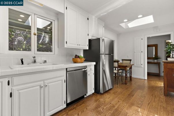 Dining room, Interior, Kitchen, Recessed Lighting, Stainless Steel Appliances, Tile Countertops, Wood Texture Flooring