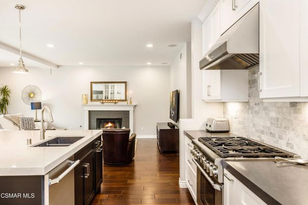 Fireplace, Interior, Kitchen, Living room, Pendant Lights, Recessed Lighting, Stainless Steel Appliances, Wood Texture Flooring