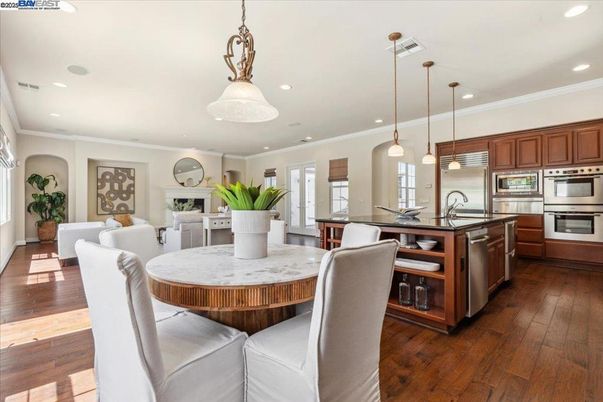 Dining room, Fireplace, Interior, Kitchen, Living room, Pendant Lights, Recessed Lighting, Stainless Steel Appliances, Wood Texture Flooring