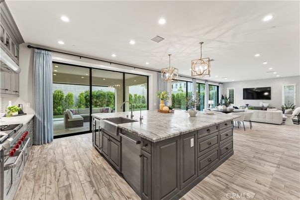 Chandelier, Interior, Kitchen, Living room, Pendant Lights, Recessed Lighting, Stainless Steel Appliances, Wood Texture Flooring