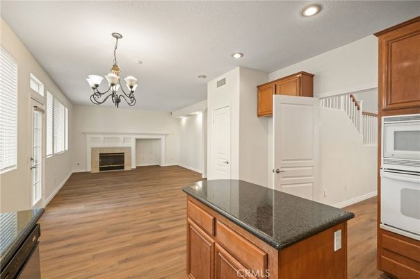 Chandelier, Fireplace, Interior, Kitchen, Recessed Lighting, Wood Texture Flooring