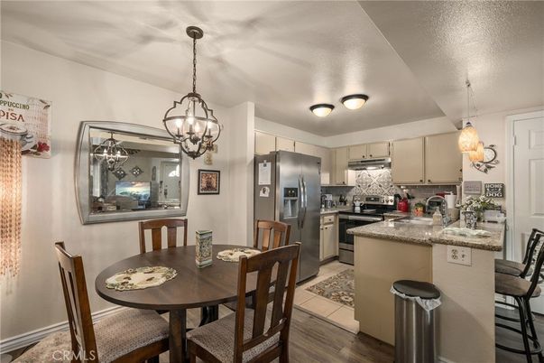 Chandelier, Dining room, Interior, Kitchen, Pendant Lights, Stainless Steel Appliances, Wood Texture Flooring