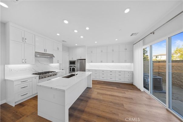 Interior, Kitchen, Marble Walls, Recessed Lighting, Stainless Steel Appliances, Wood Texture Flooring