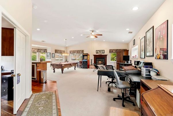Billiard Table, Chandelier, Fireplace, Game Room, Home Office, Interior, Living room, Pendant Lights, Recessed Lighting, Wood Texture Flooring