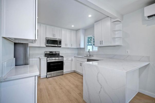 Interior, Kitchen, Marble Walls, Recessed Lighting, Stainless Steel Appliances, Wood Texture Flooring