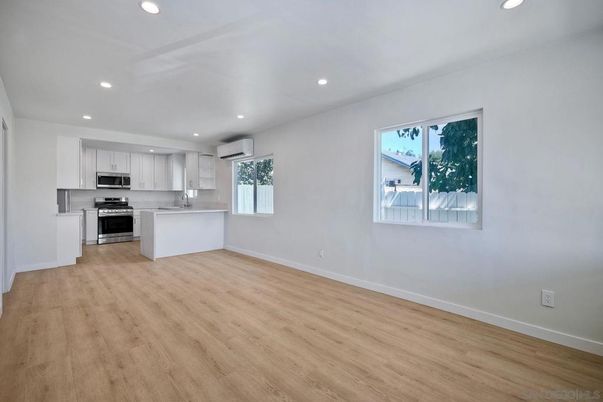 Empty room, Interior, Kitchen, Recessed Lighting, Stainless Steel Appliances, Wood Texture Flooring