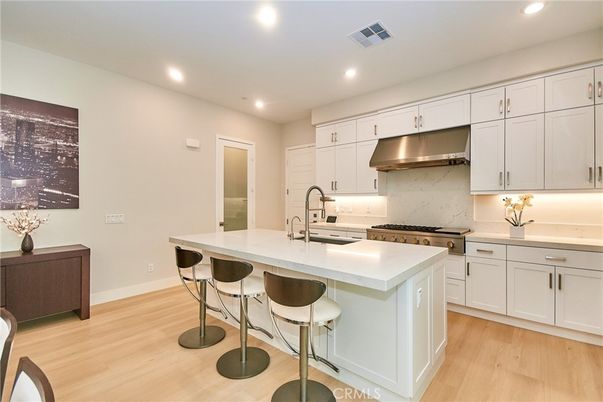 Interior, Kitchen, Marble Walls, Recessed Lighting, Stainless Steel Appliances, Wood Texture Flooring