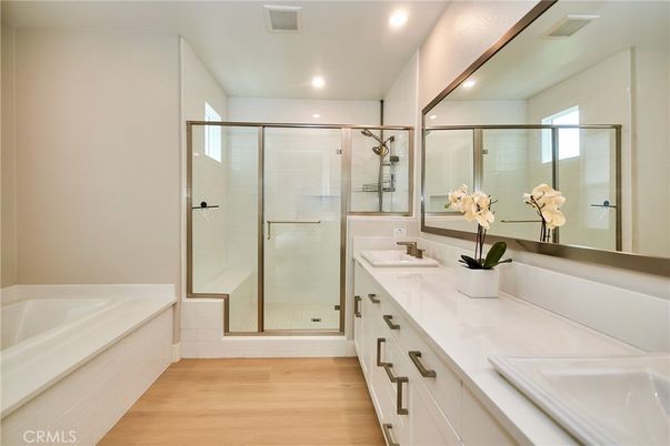 Bathroom, Dual Sink Vanities, Glass Shower, Interior, Recessed Lighting, Wood Texture Flooring