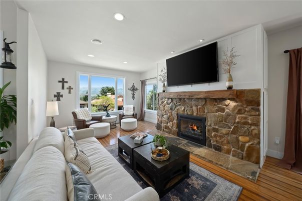 Dining room, Fireplace, Interior, Living room, Recessed Lighting, Stone Walls, Wood Texture Flooring