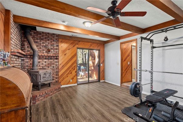 Fireplace, Fitness Equipment, Interior, Stone Walls, Wood Texture Flooring, Wooden Walls