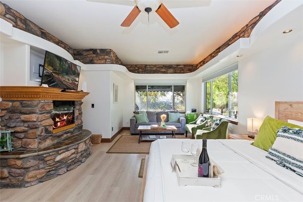 Fireplace, Interior, Living room, Recessed Lighting, Stone Walls, Wood Texture Flooring