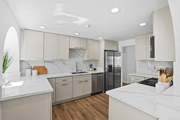 Interior, Kitchen, Marble Walls, Recessed Lighting, Stainless Steel Appliances, Wood Texture Flooring
