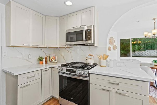 Interior, Kitchen, Marble Walls, Recessed Lighting, Stainless Steel Appliances, Wood Texture Flooring