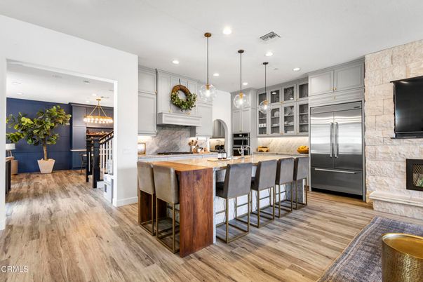 Fireplace, Interior, Kitchen, Pendant Lights, Recessed Lighting, Stainless Steel Appliances, Stone Walls, Wood Texture Flooring