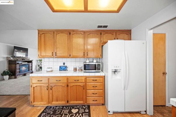 Fireplace, Interior, Kitchen, Tile Countertops, Wood Texture Flooring