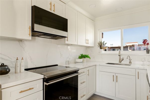 Interior, Kitchen, Marble Walls, Recessed Lighting, Stainless Steel Appliances, Wood Texture Flooring