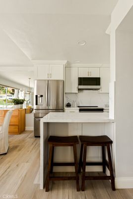 Interior, Kitchen, Marble Walls, Pendant Lights, Recessed Lighting, Stainless Steel Appliances, Wood Texture Flooring