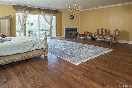 Bedroom, Chandelier, Fireplace, Interior, Recessed Lighting, Wood Texture Flooring