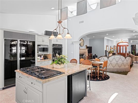 Chandelier, Dining room, Fireplace, Interior, Kitchen, Living room, Pendant Lights, Recessed Lighting, Stainless Steel Appliances