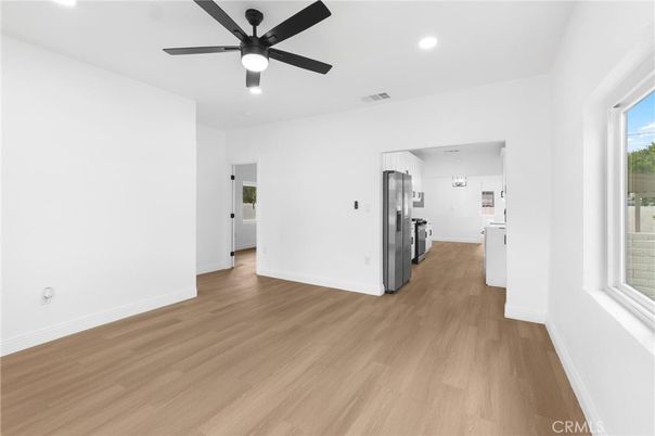 Empty room, Interior, Kitchen, Recessed Lighting, Stainless Steel Appliances, Wood Texture Flooring