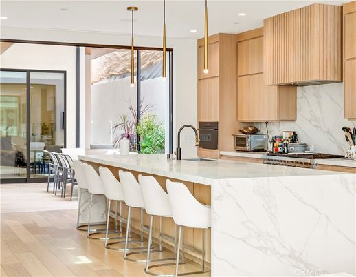 Interior, Kitchen, Marble Walls, Pendant Lights, Recessed Lighting, Stainless Steel Appliances, Wood Texture Flooring